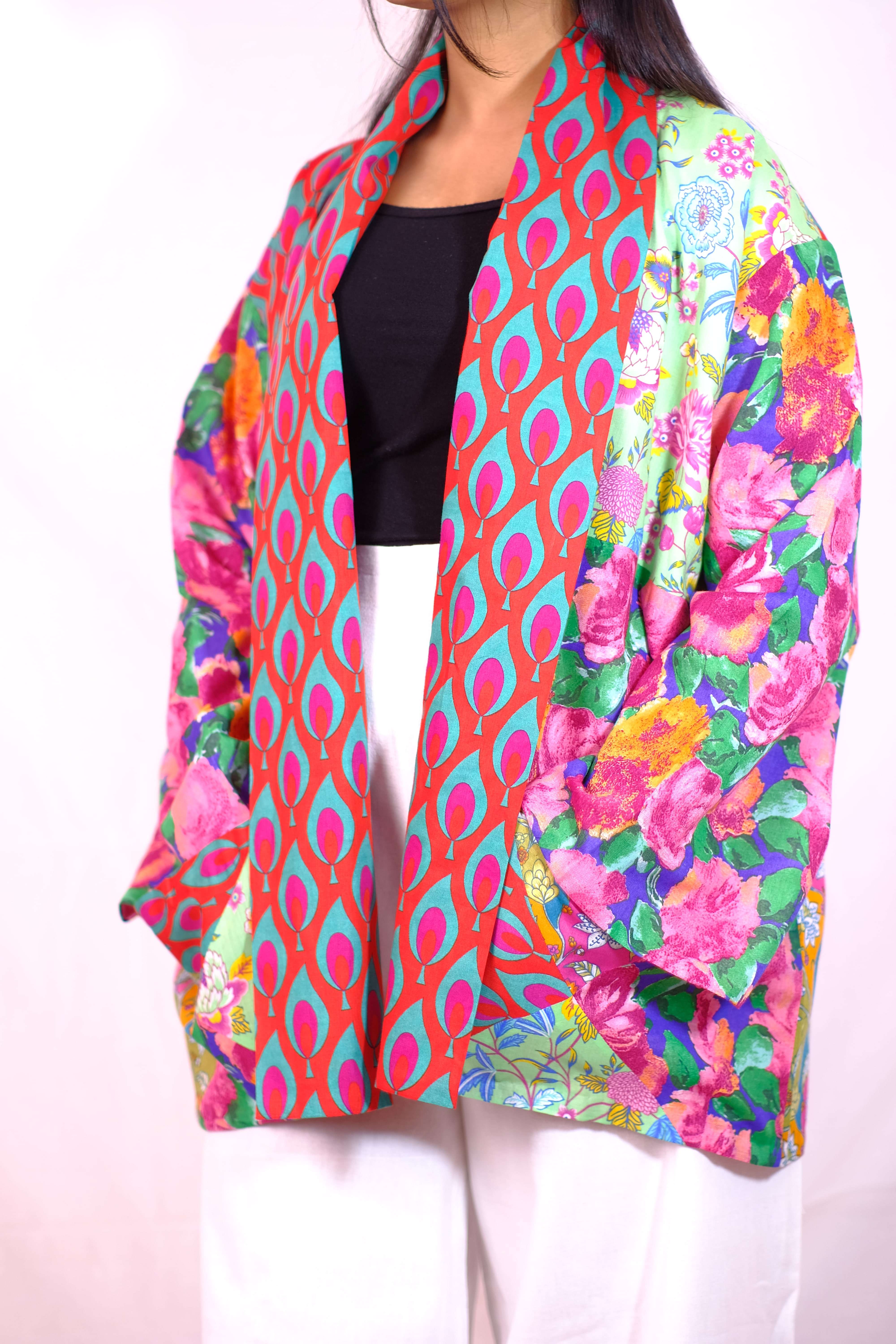 A vibrant patchwork kimono-style jacket blending floral and geometric prints for a bold fashion statement.