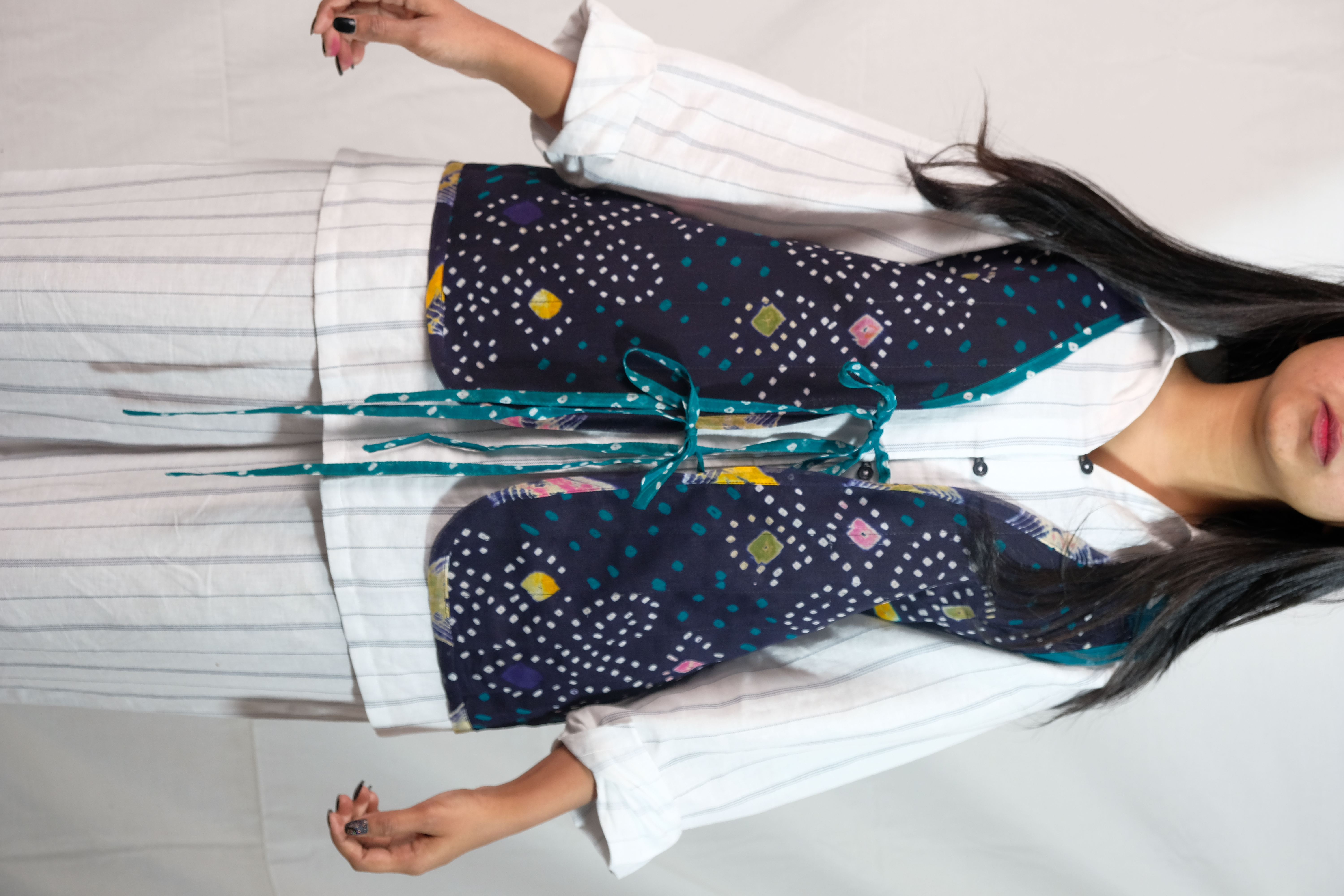 Reversible vest with vibrant print on a side and solid earthy tone on other.